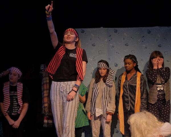 young people dressed as pirates performing in a Word Lounge Theatre Company show